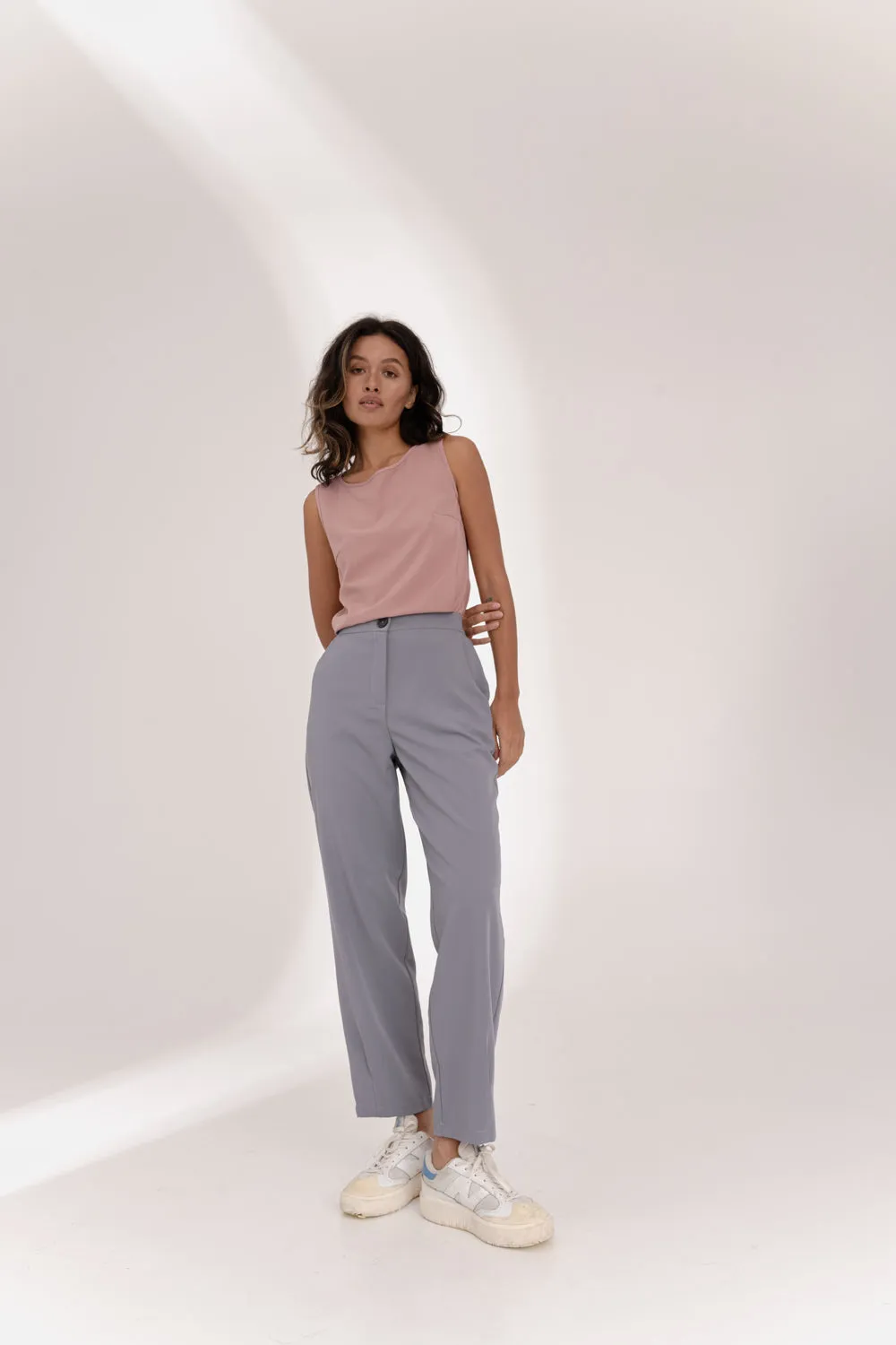 Gray trousers with an elasticated waistband and pleats at the hem