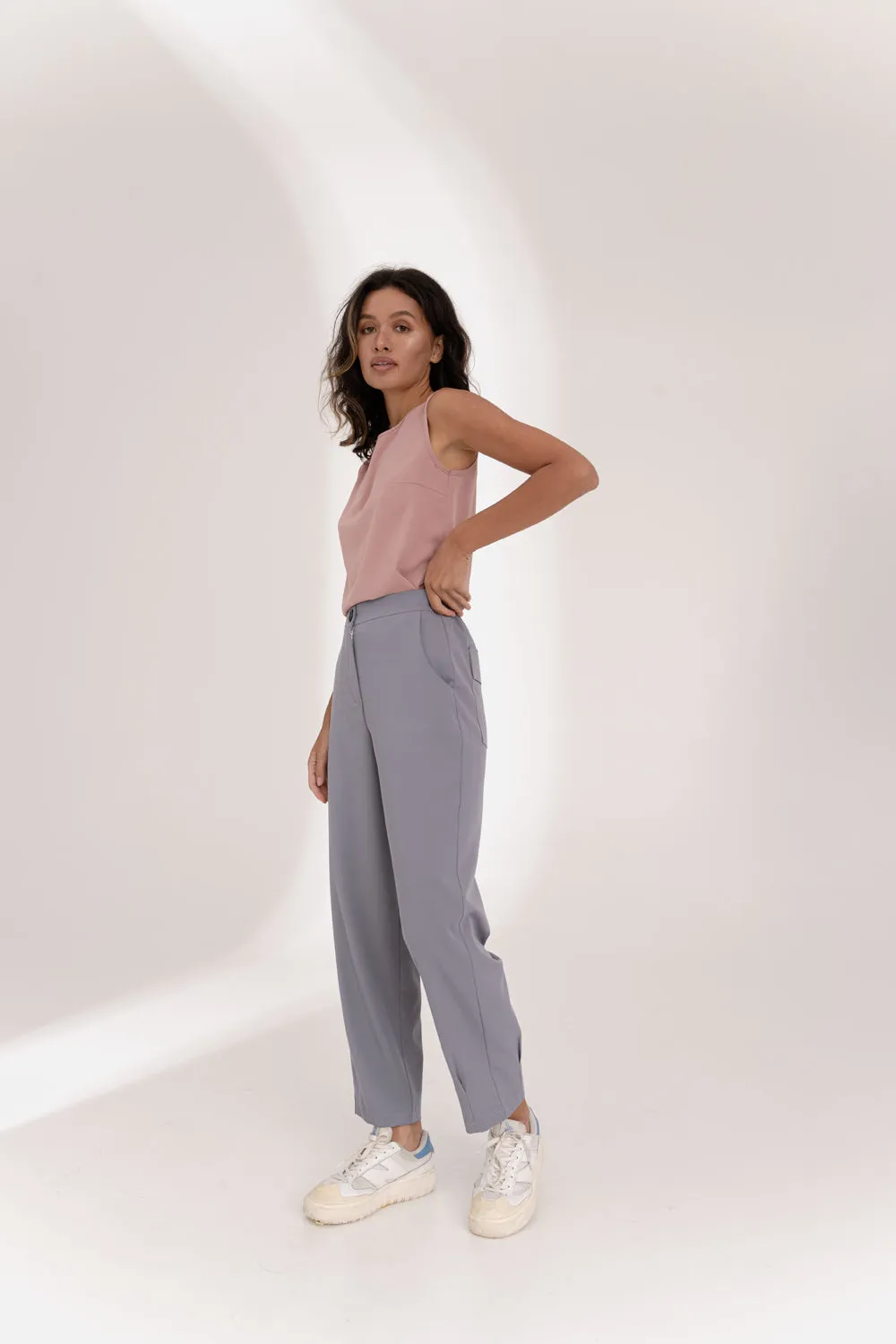 Gray trousers with an elasticated waistband and pleats at the hem